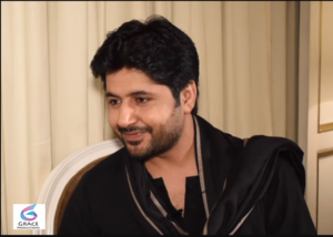 Pakistani actor Imran Ashraf smiling for the camera.