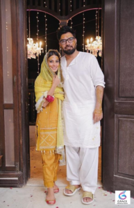 Iqra Aziz on her wedding day with Yasir Hussain, wearing traditional bridal attire, capturing a joyful and elegant moment from their 2019 wedding ceremony in Karachi.