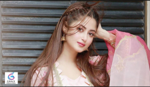 Pakistani actress Sajal Ali smiling during a glamorous portrait session, showcasing her elegant style and award-winning career in television and film.