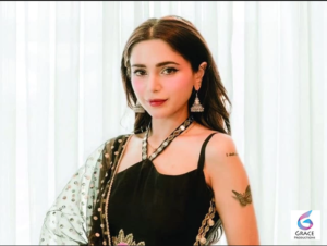 Aima Baig wearing a stylish traditional outfit while posing gracefully for a professional portrait.