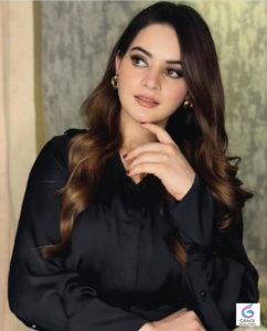 Minal Khan smiling during a stylish photoshoot, showcasing the popular Pakistani actress and fashion model.
