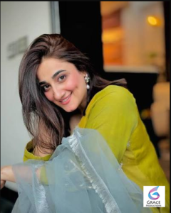 Nimra Mehra smiling during a photoshoot, showcasing the Pakistani singer's elegant style and confident personality.