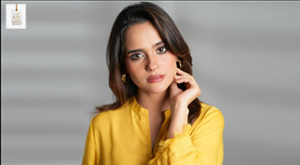Rabya Kulsoom posing gracefully during a professional photoshoot wearing a stylish traditional Pakistani outfit.