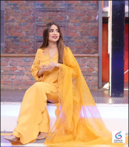 Pakistani actress Saboor Aly posing gracefully in a stylish outfit during a professional studio photoshoot.