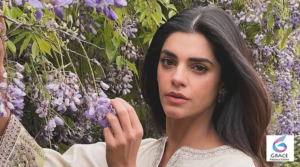 Sanam Saeed wearing a modern outfit while posing confidently for a professional portrait with a graceful smile.