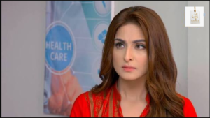 Aruba Mirza smiling during a Pakistani television event in an elegant traditional look