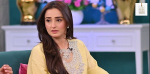 Momal Sheikh smiling during a stylish public appearance