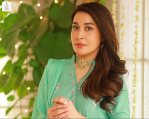 Shaista Lodhi smiling during a television appearance in an elegant traditional outfit