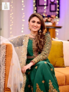 Tanya Hussain smiling in an elegant outfit during a professional photoshoot